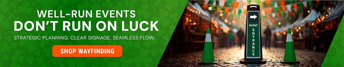 Green traffic cones and a black SD2K wayfinding sign reading \"Event Entrance\" with an arrow, set along a festive outdoor event corridor with string lights and green and orange banners. Text reads \"Well-Run Events Don\'t Run on Luck – Strategic Planning